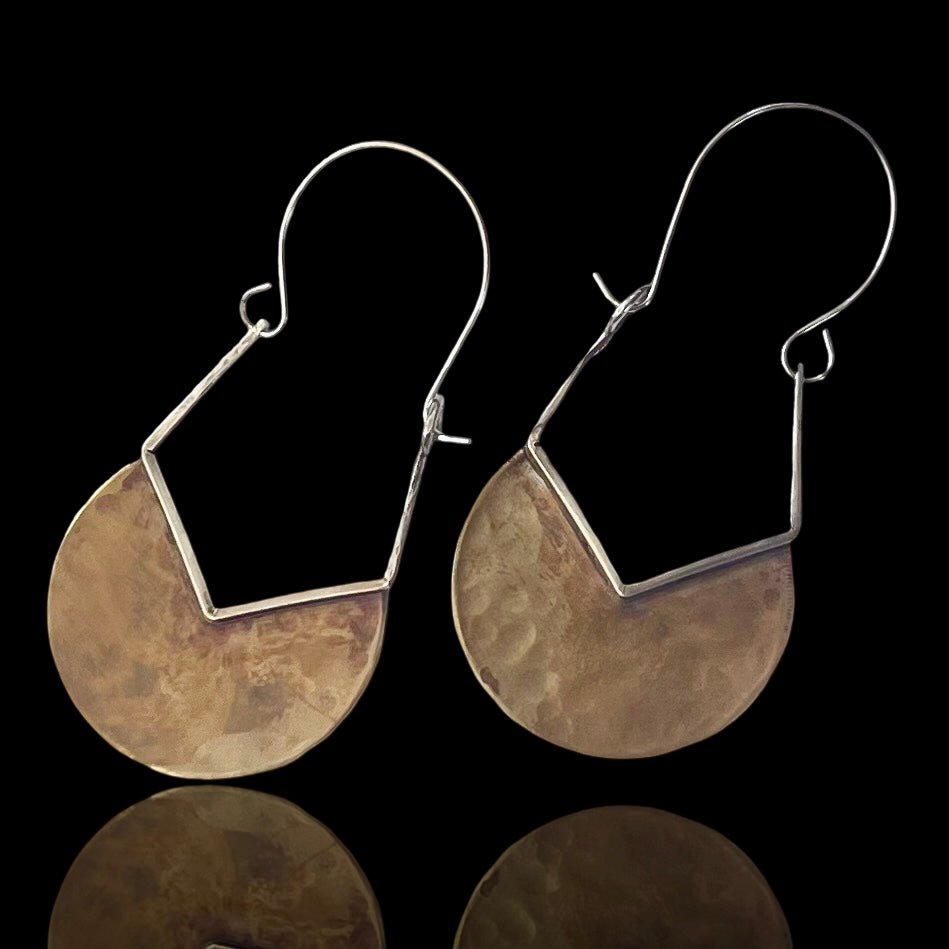 Hammered brass almost half circles with v-shaped cut trimmed in silver with an upside-down pentagon. Sterling silver earwire completes this side dangling earring. Very clean and attractive design.